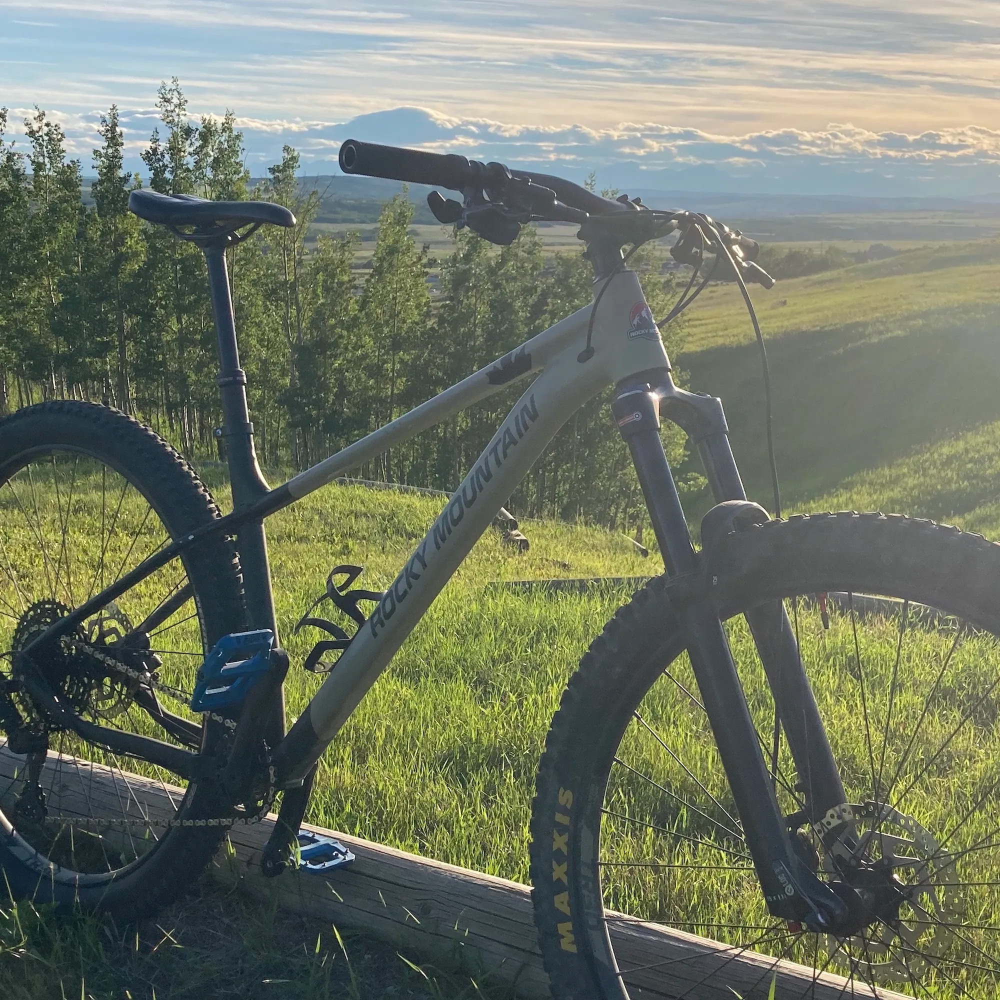 A hardtail mountain bike set against the backdrop of the Rocky Mountains
